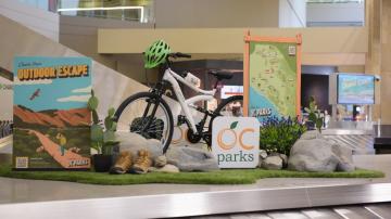 A mountain bike positioned on top of an airport baggage carousel. 