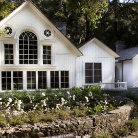 White 1800s home with large windows