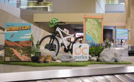 A mountain bike positioned on top of an airport baggage carousel. 